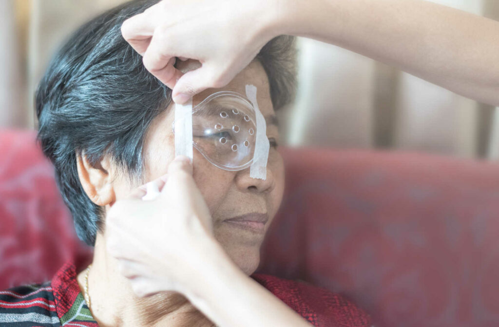 An elderly woman getting an eye patch on her eye after cataract surgery.